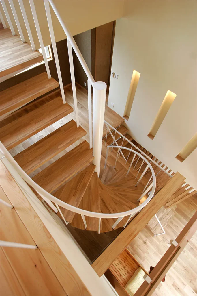 2階から3階へつながる螺旋階段。白の手すりで圧迫感を低減。